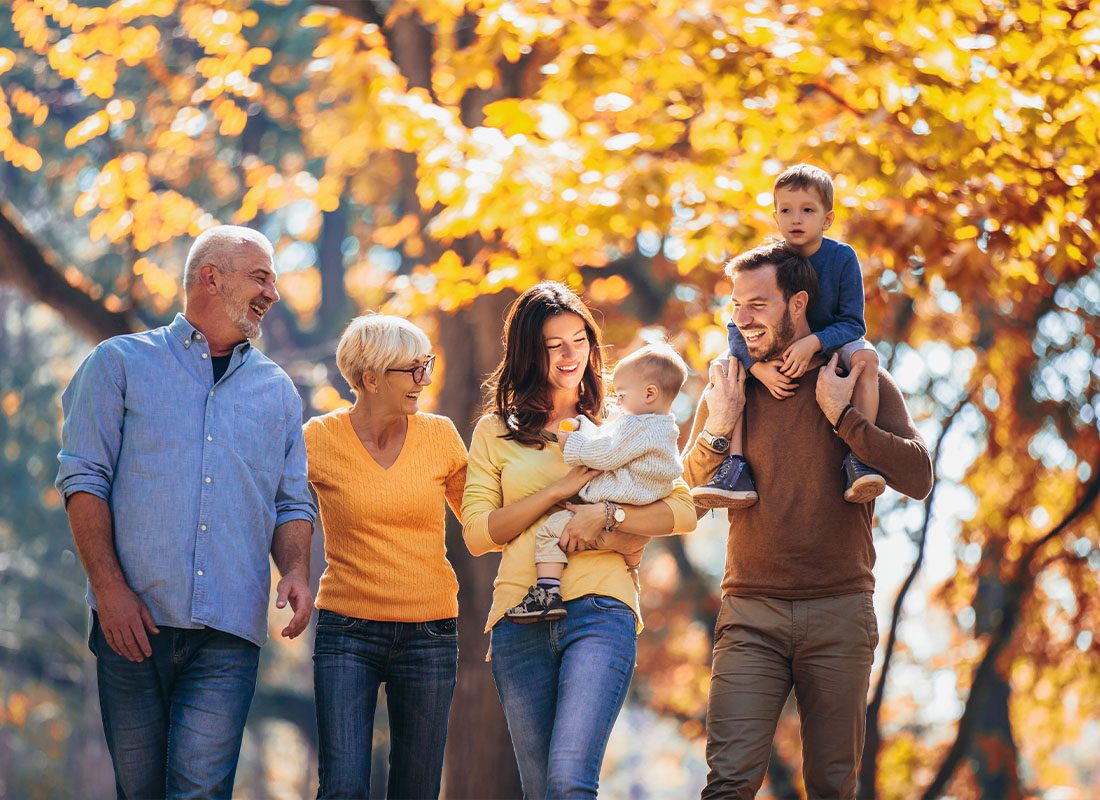 Personal Insurance - Multi Generational Family Having Fun at the Park in the Season of Fall